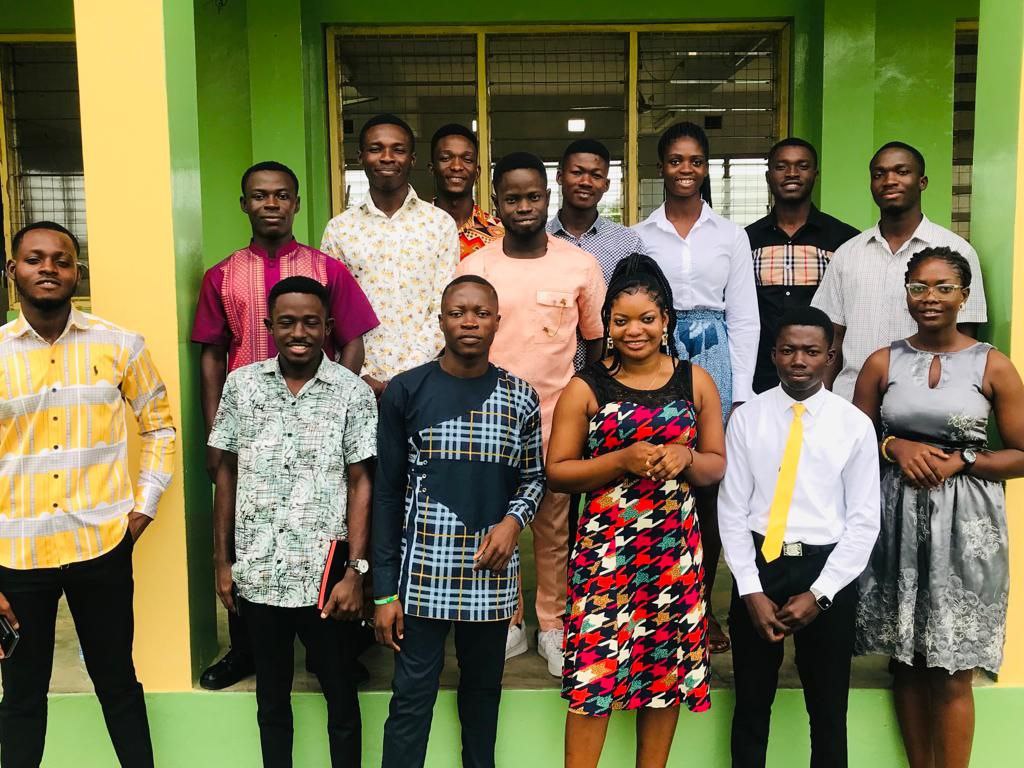 Fosco Chapter members in front of green and yellow pillars